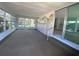 Bright sunroom with large windows, unique mural, and sliding glass door access to the home's interior at 726 Viking Ave, Tavares, FL 32778