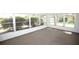 Bright sunroom with large windows offering serene views of the landscaped surroundings at 726 Viking Ave, Tavares, FL 32778