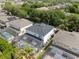 Aerial view of a home with a screened pool and lush green landscaping at 8029 Acadia Estates Ct, Kissimmee, FL 34747