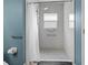 An updated bathroom with walk-in shower with safety bars and modern fixtures at 8029 Acadia Estates Ct, Kissimmee, FL 34747