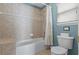 Bathroom featuring tiled tub and shower combination, toilet, and window at 8029 Acadia Estates Ct, Kissimmee, FL 34747
