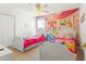 Themed bedroom featuring two beds, a ceiling fan and a princess mural at 8029 Acadia Estates Ct, Kissimmee, FL 34747
