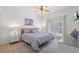 A bedroom features hardwood floors, ceiling fan and walk-out access to the backyard at 8029 Acadia Estates Ct, Kissimmee, FL 34747