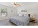 Bright bedroom with a bed, neutral walls and a large window for natural light at 8029 Acadia Estates Ct, Kissimmee, FL 34747