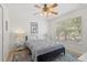 Bedroom with a Mickey Mouse poster, a ceiling fan with lights, and a window with blinds at 8029 Acadia Estates Ct, Kissimmee, FL 34747