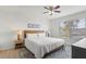 Bright bedroom with a bed, neutral walls and a large window for natural light at 8029 Acadia Estates Ct, Kissimmee, FL 34747