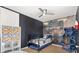 Star Wars themed bedroom with hardwood floors, built-in shelving, and a ceiling fan at 8029 Acadia Estates Ct, Kissimmee, FL 34747