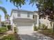 Charming two-story home with a two-car garage, well-maintained landscaping, and a warm, inviting ambiance at 8029 Acadia Estates Ct, Kissimmee, FL 34747