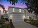 Charming two-story home with a two-car garage, well-maintained landscaping, and a warm, inviting ambiance at 8029 Acadia Estates Ct, Kissimmee, FL 34747