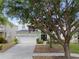 Inviting two-story home featuring a two-car garage, lush landscaping, and a welcoming front entrance at 8029 Acadia Estates Ct, Kissimmee, FL 34747
