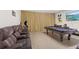 Spacious game room featuring a pool table, arcade games, and comfortable seating at 8029 Acadia Estates Ct, Kissimmee, FL 34747
