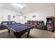 Game room with a pool table, comfortable seating, and arcade games at 8029 Acadia Estates Ct, Kissimmee, FL 34747