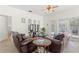 A cozy living room with a ceiling fan, tile floors, and leather furniture at 8029 Acadia Estates Ct, Kissimmee, FL 34747