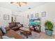 Open living room area with hardwood flooring and view of a large screen TV at 8029 Acadia Estates Ct, Kissimmee, FL 34747