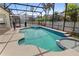 Sparkling pool with spa, surrounded by a screened enclosure and lush landscaping at 8029 Acadia Estates Ct, Kissimmee, FL 34747