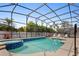 Beautiful screened-in pool area with spa and ample space for lounging at 8029 Acadia Estates Ct, Kissimmee, FL 34747