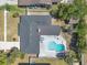 Aerial view of home showcasing the roof, pool, patio and surrounding landscaping at 8720 Larwin Ln, Orlando, FL 32817