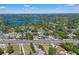 Panoramic aerial view capturing a residential area with lakes and roadways under a bright blue sky at 8720 Larwin Ln, Orlando, FL 32817