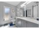 Bathroom featuring a double sink vanity, with stylish decor, and a window at 8720 Larwin Ln, Orlando, FL 32817