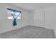 Bright bedroom with modern floors, closet, and natural light from the window at 8720 Larwin Ln, Orlando, FL 32817