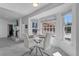 Cozy breakfast nook with a round table, bright bay windows, and tranquil outdoor views for relaxed dining at 8720 Larwin Ln, Orlando, FL 32817