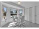 Bright breakfast nook with a glass table, white chairs, and a view of the pool area at 8720 Larwin Ln, Orlando, FL 32817
