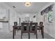 Elegant dining room with a sleek table, modern chairs, and mirrored wall, perfect for entertaining at 8720 Larwin Ln, Orlando, FL 32817