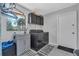 Well-equipped laundry room featuring modern washer and dryer and convenient utility sink at 8720 Larwin Ln, Orlando, FL 32817
