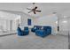 Comfortable living room with vaulted ceiling, fan and stylish blue furniture at 8720 Larwin Ln, Orlando, FL 32817