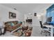 Inviting living area with a comfortable sofa, stylish rug, and bright workspace, great for relaxation at 8720 Larwin Ln, Orlando, FL 32817