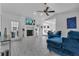 Bright living room featuring tile floors, fireplace, and comfortable seating area at 8720 Larwin Ln, Orlando, FL 32817