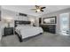 Bedroom featuring carpet, fan, dark furniture, and bathroom access at 8720 Larwin Ln, Orlando, FL 32817