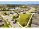 Aerial view capturing a beautiful community, featuring well-maintained lawns and a tranquil lake in the background at 9687 Lost Creek Dr, Winter Garden, FL 34787