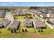 Aerial view displays properties with spacious lawns, a backyard play structure, and serene neighborhood surroundings at 9687 Lost Creek Dr, Winter Garden, FL 34787