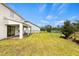 Lush backyard with well-kept lawn and covered patio, offering a serene outdoor space for relaxation and recreation at 9687 Lost Creek Dr, Winter Garden, FL 34787