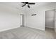 Bright bedroom features neutral walls and carpet, with doorway and a modern ceiling fan at 9687 Lost Creek Dr, Winter Garden, FL 34787