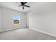 Well-lit bedroom with neutral carpet and walls, features a window and an open doorway at 9687 Lost Creek Dr, Winter Garden, FL 34787