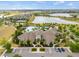 Community clubhouse featuring a resort-style pool, lake views, and ample parking at 9687 Lost Creek Dr, Winter Garden, FL 34787