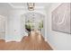 Hallway with views into other rooms, beautiful lighting, and wood look tile floors at 9687 Lost Creek Dr, Winter Garden, FL 34787