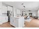 Modern kitchen island with white cabinets, stainless steel appliances, and seating at 9687 Lost Creek Dr, Winter Garden, FL 34787