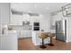 Modern kitchen with white cabinets, stainless steel appliances, and a functional island at 9687 Lost Creek Dr, Winter Garden, FL 34787