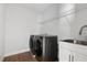 Laundry room featuring modern washer and dryer, a sink with counter space, and upper shelving for storage at 9687 Lost Creek Dr, Winter Garden, FL 34787
