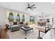 Open-concept living space with large windows, a sectional sofa, and a dining area, perfect for modern living at 9687 Lost Creek Dr, Winter Garden, FL 34787
