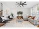 Bright living room featuring a neutral color palette, a modern ceiling fan, and comfortable seating arrangement at 9687 Lost Creek Dr, Winter Garden, FL 34787