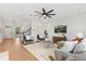 Spacious living room with a ceiling fan, comfortable seating, and a view of the staircase and hallway at 9687 Lost Creek Dr, Winter Garden, FL 34787