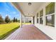 Covered brick patio with ample space for outdoor seating and entertaining, providing a relaxing view of the backyard at 9687 Lost Creek Dr, Winter Garden, FL 34787