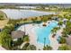 Aerial view of the community pool with lush landscaping and lake views at 9687 Lost Creek Dr, Winter Garden, FL 34787