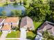 An aerial view of home featuring a long driveway and manicured front lawn at 150 Golfside Cir, Sanford, FL 32773