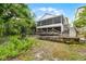 Backyard of home showing porch, yard and the home's concrete support structure at 150 Golfside Cir, Sanford, FL 32773