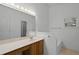 Bright bathroom featuring a large vanity, a built-in tub, and ample counter space at 150 Golfside Cir, Sanford, FL 32773